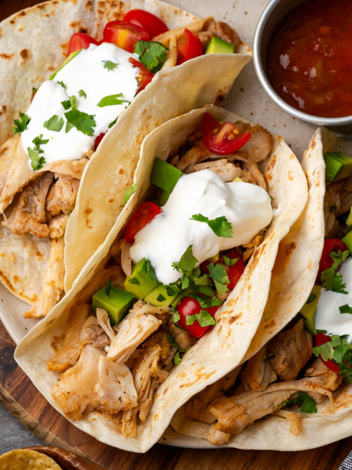 Southwest chicken shredded and served in tortillas as tacos.