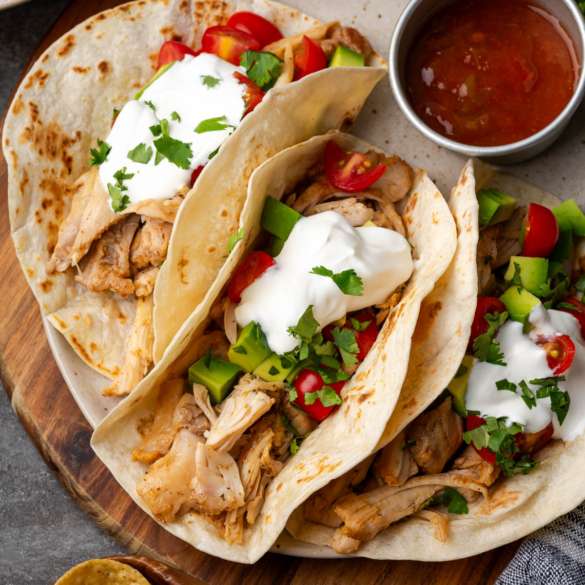 Southwest chicken shredded and served in tortillas as tacos.