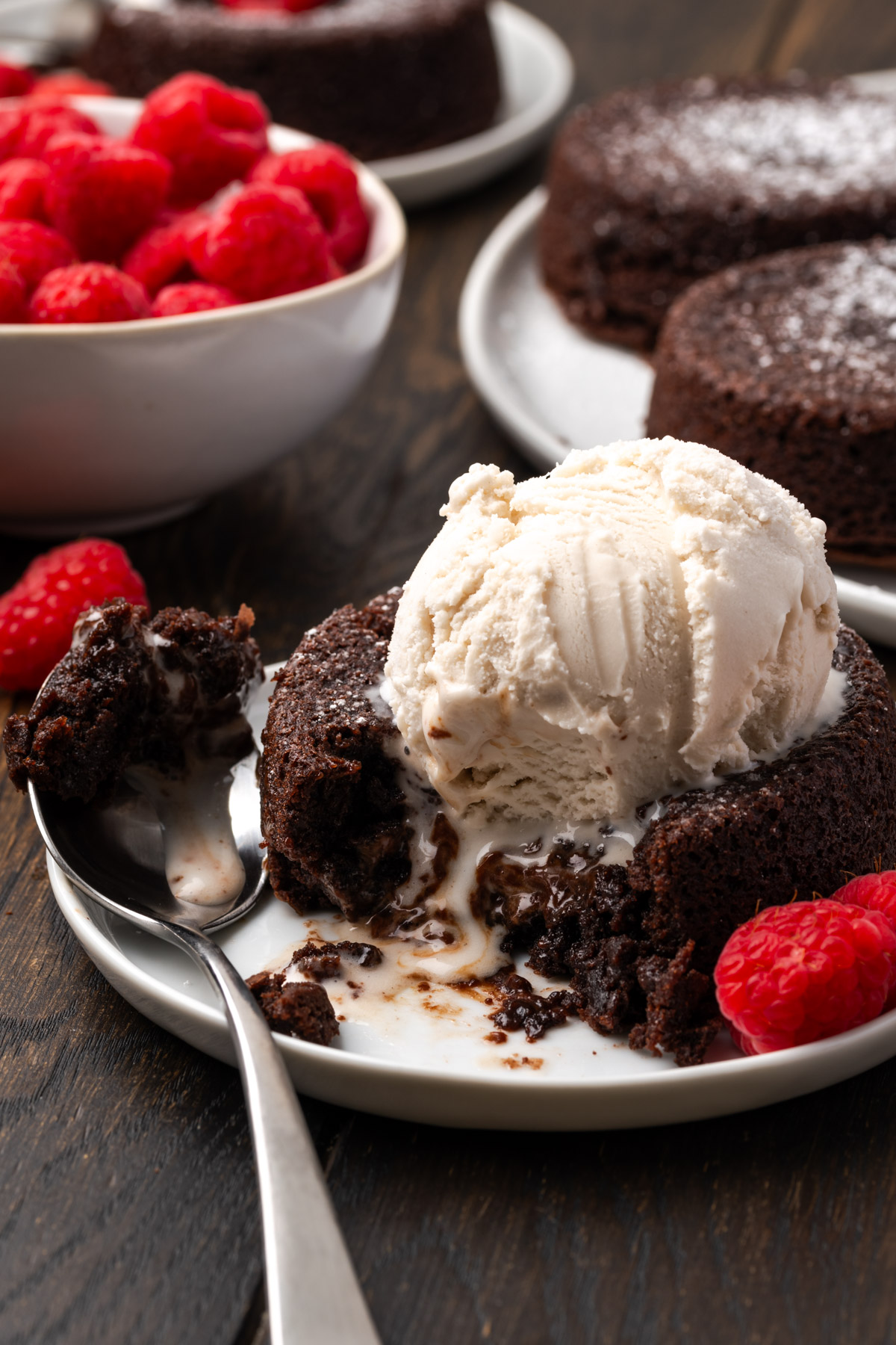 Lava cake with ice cream on top melting a bit.