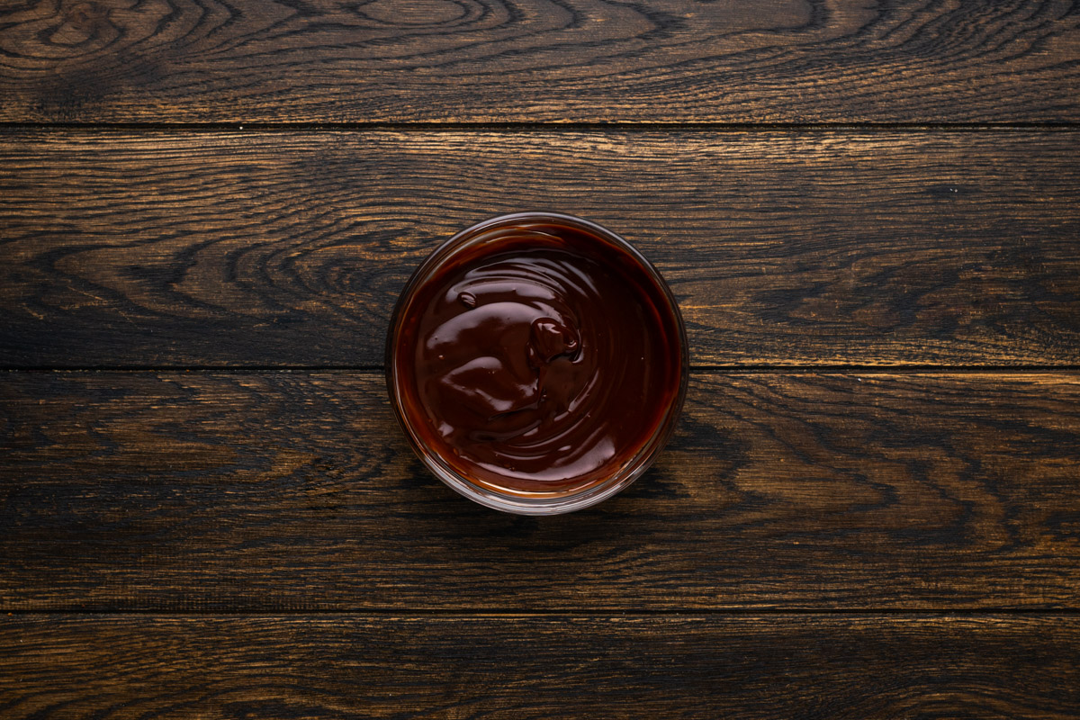 Semisweet chocolate with the heavy cream combined in a small bowl.