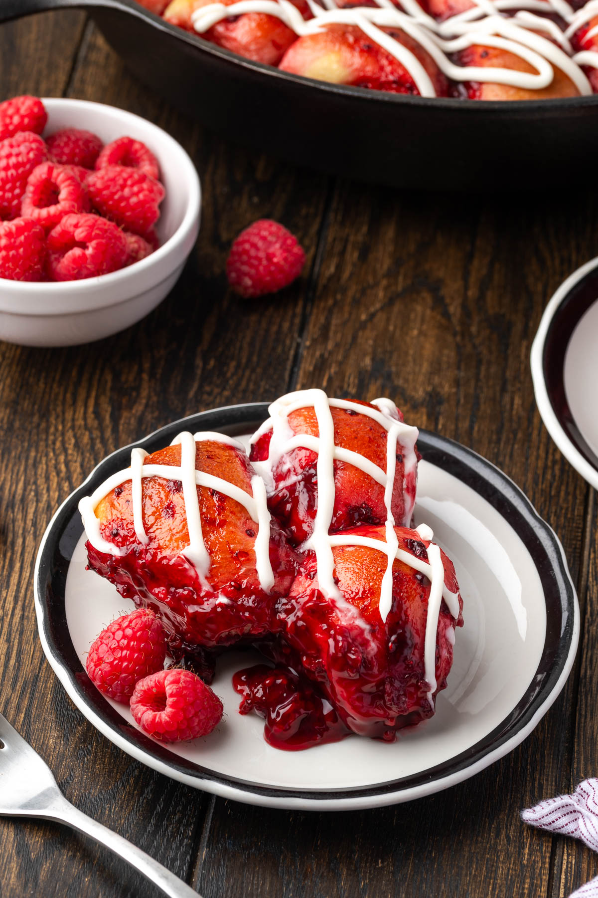 Raspberry bread with icing on a plate.