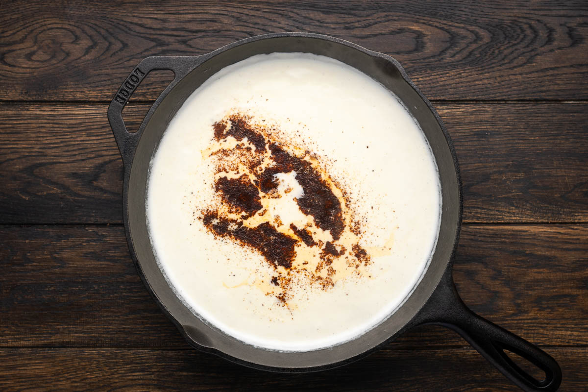 Cream in a skillet with the chili powder added.