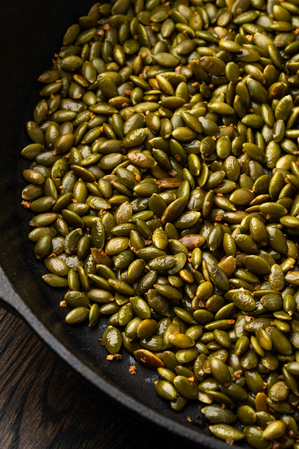 Spiced pepitas in a cast iron skillet.