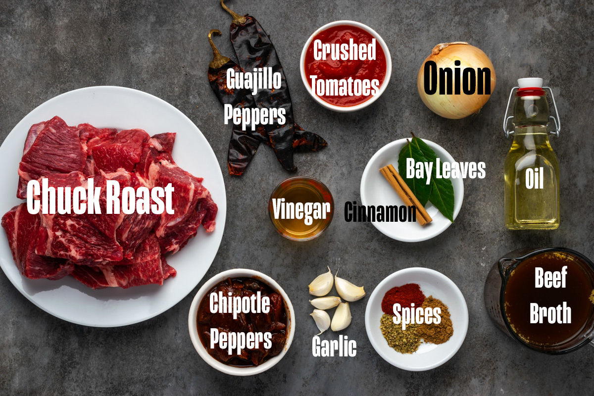 Ingredients to make birria in bowls on a table.