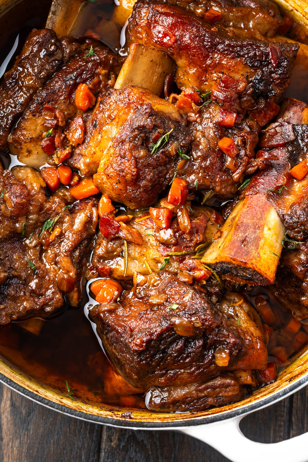 Short ribs cooking in a dutch oven.