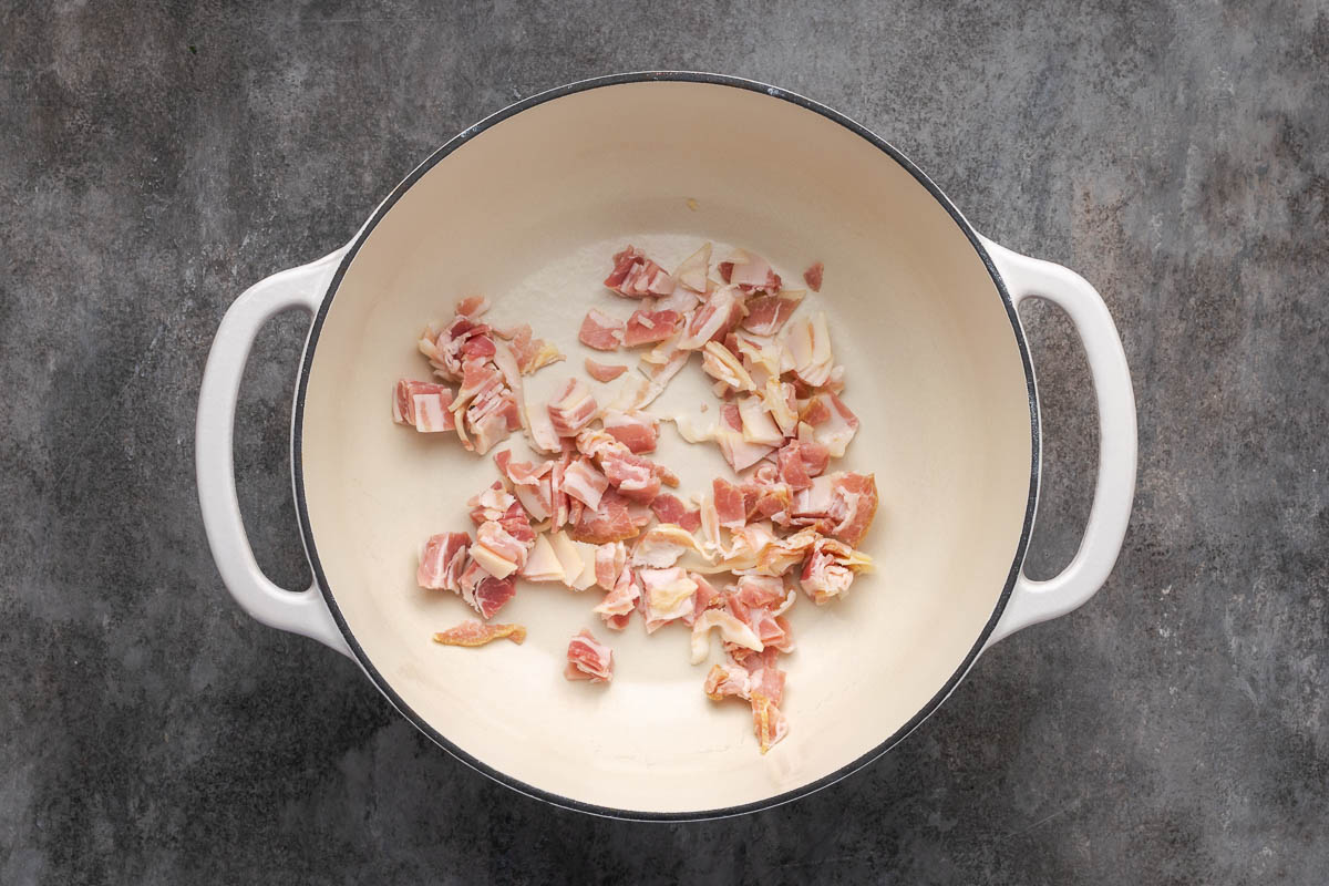 Pancetta added to the Dutch oven.