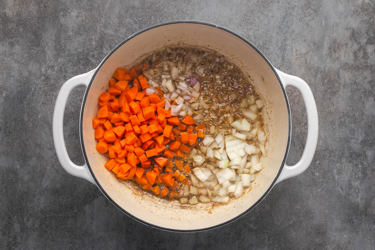 Carrots and onion added to the pot to cook.