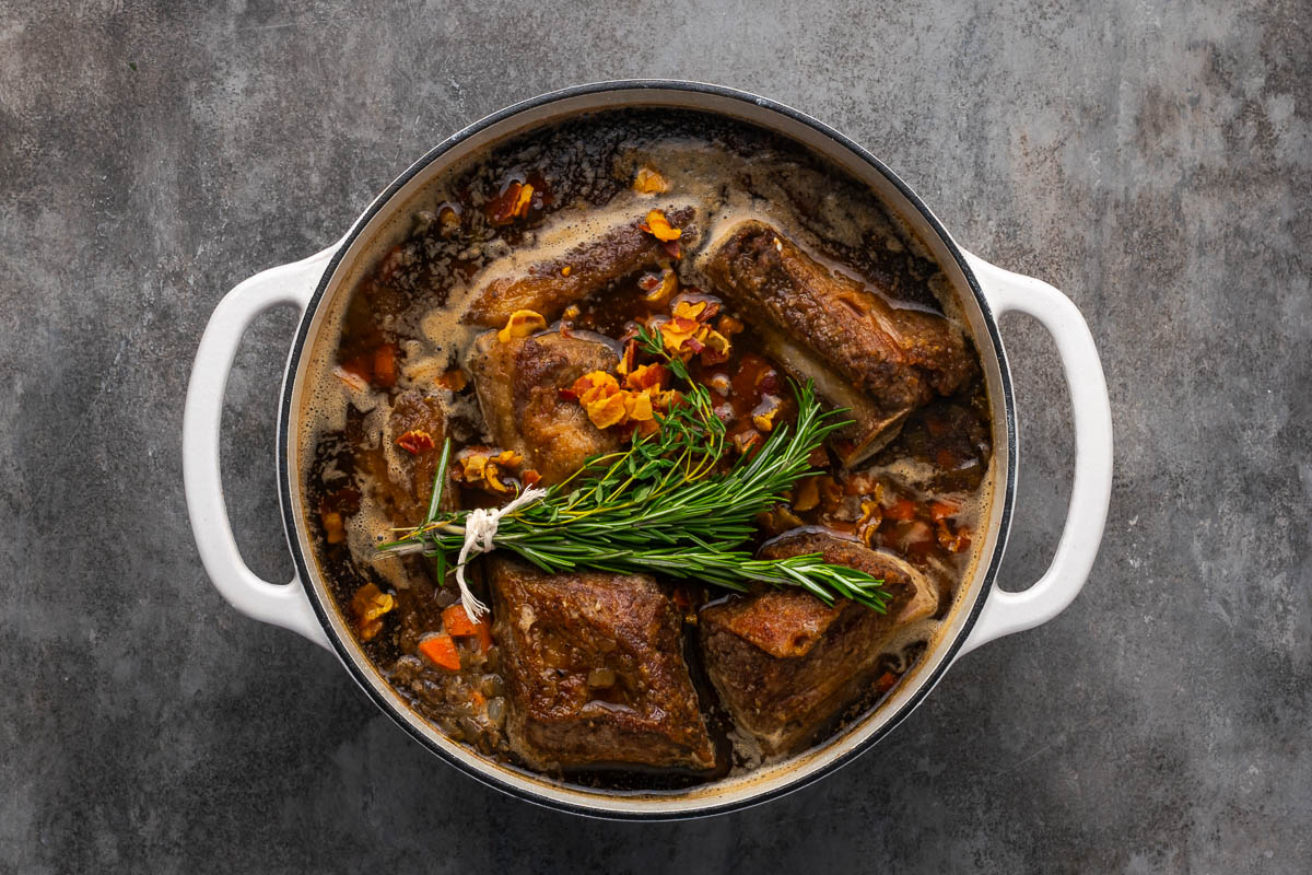 Short ribs added back to the dutch oven to finish cooking.