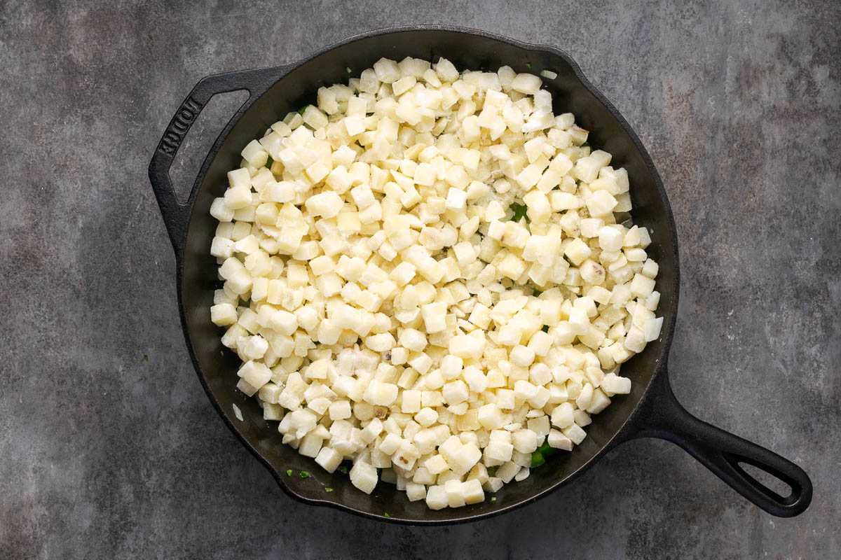Potatoes added to the skillet.