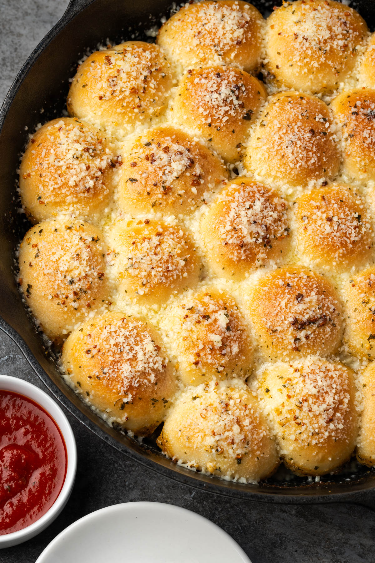 A skillet filled with garlic parmesan pull apart bread.