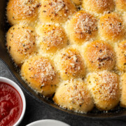 Garlic parmesan pull apart rolls in a skillet.