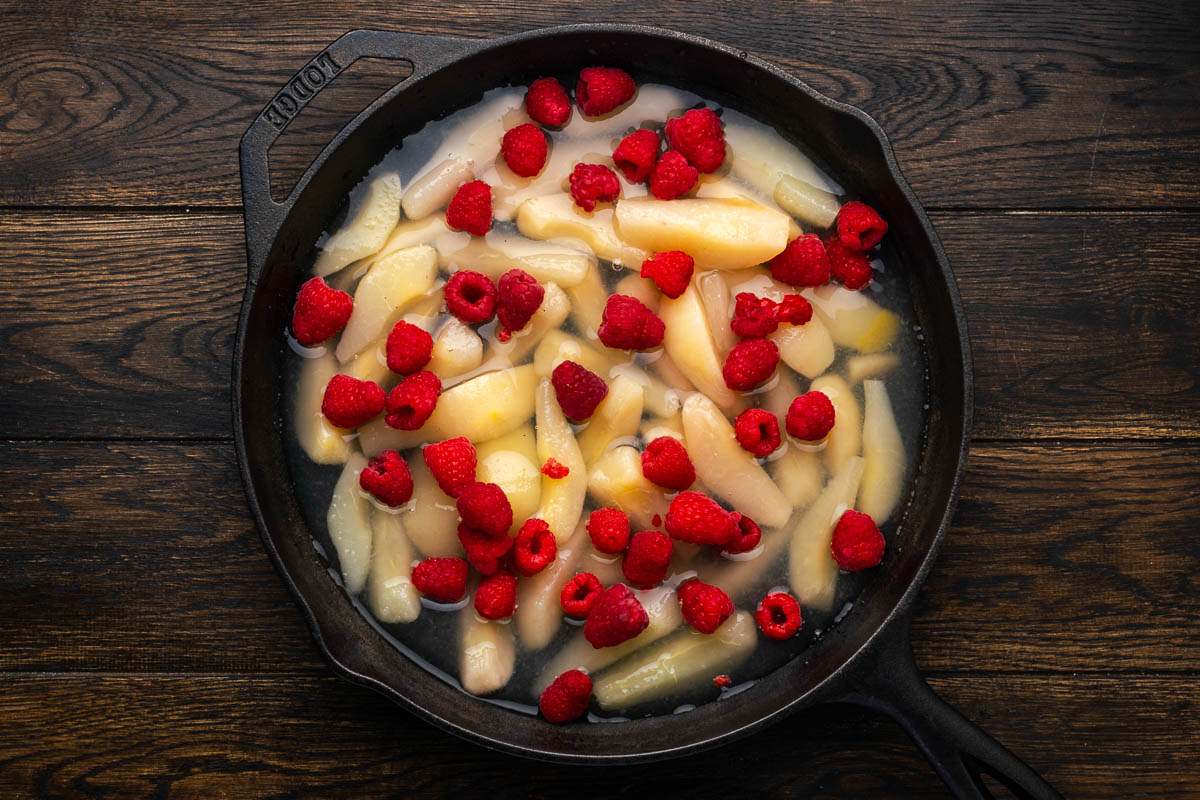 Canned pears, syrup, and the raspberries into your Dutch oven.