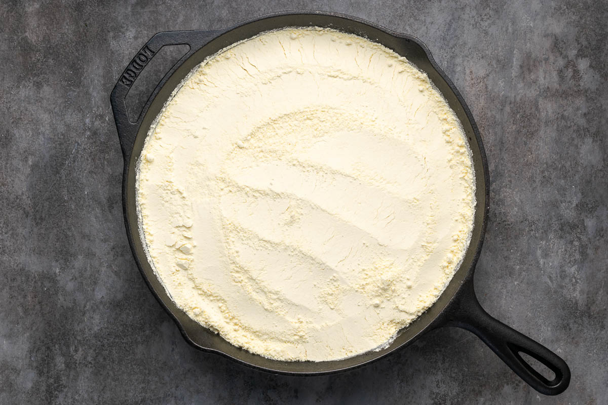 Yellow cake mix evenly spread over the fruit layers.