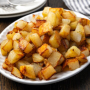 Skillet fried potatoes on a serving plate.