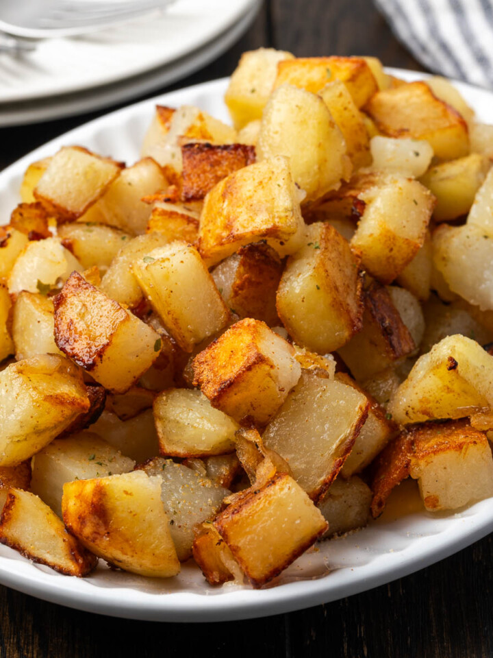 Skillet fried potatoes on a serving plate.