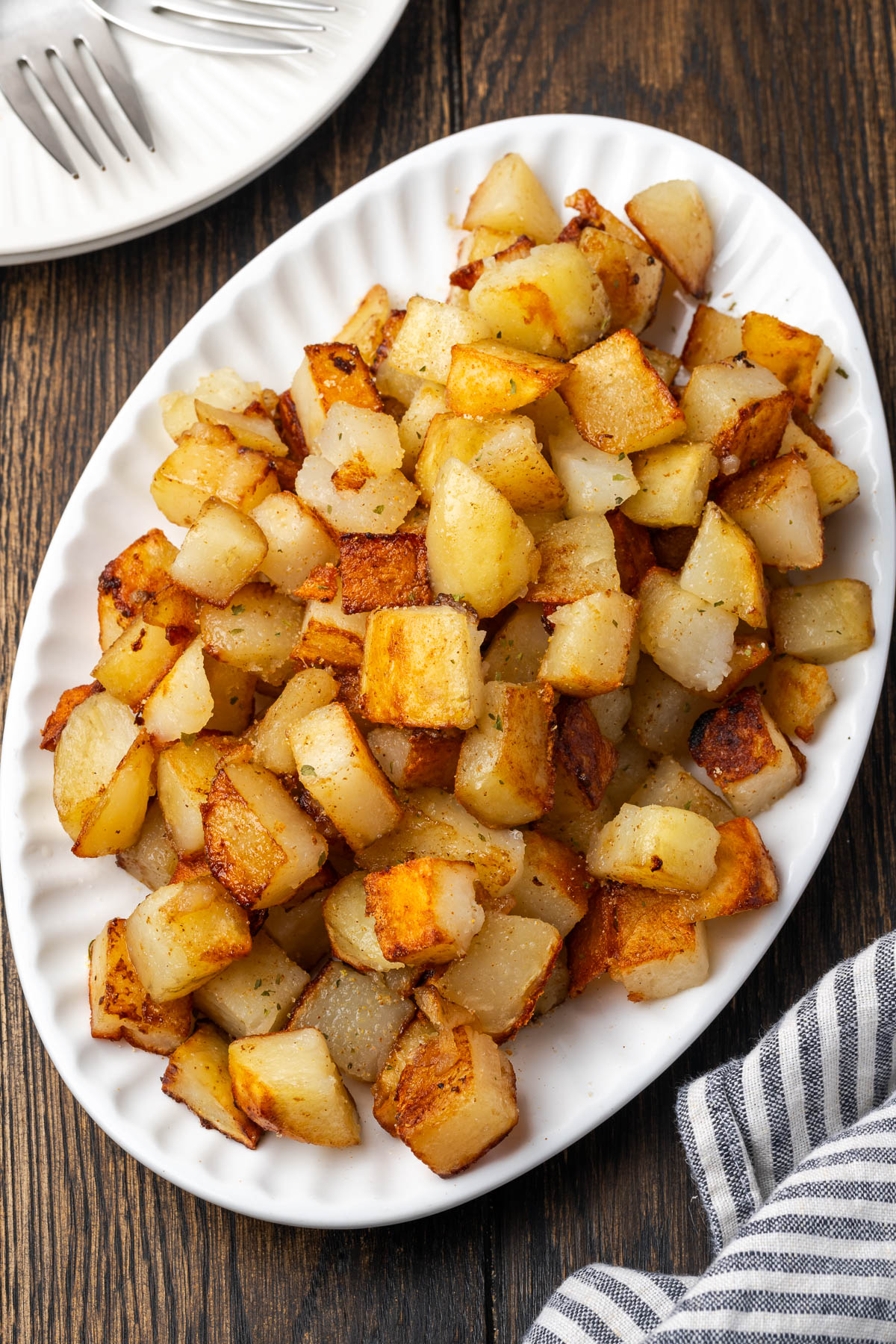 A plate filled with skillet fried potatoes.
