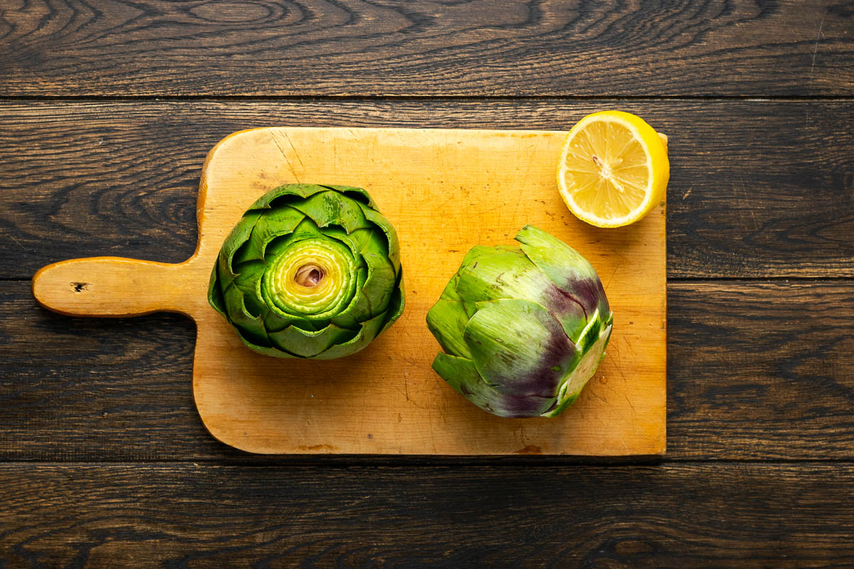 The stems trimmed and cut about an inch off the tops of the artichokes.