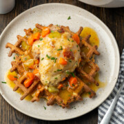 Braised chicken thighs on a plate.