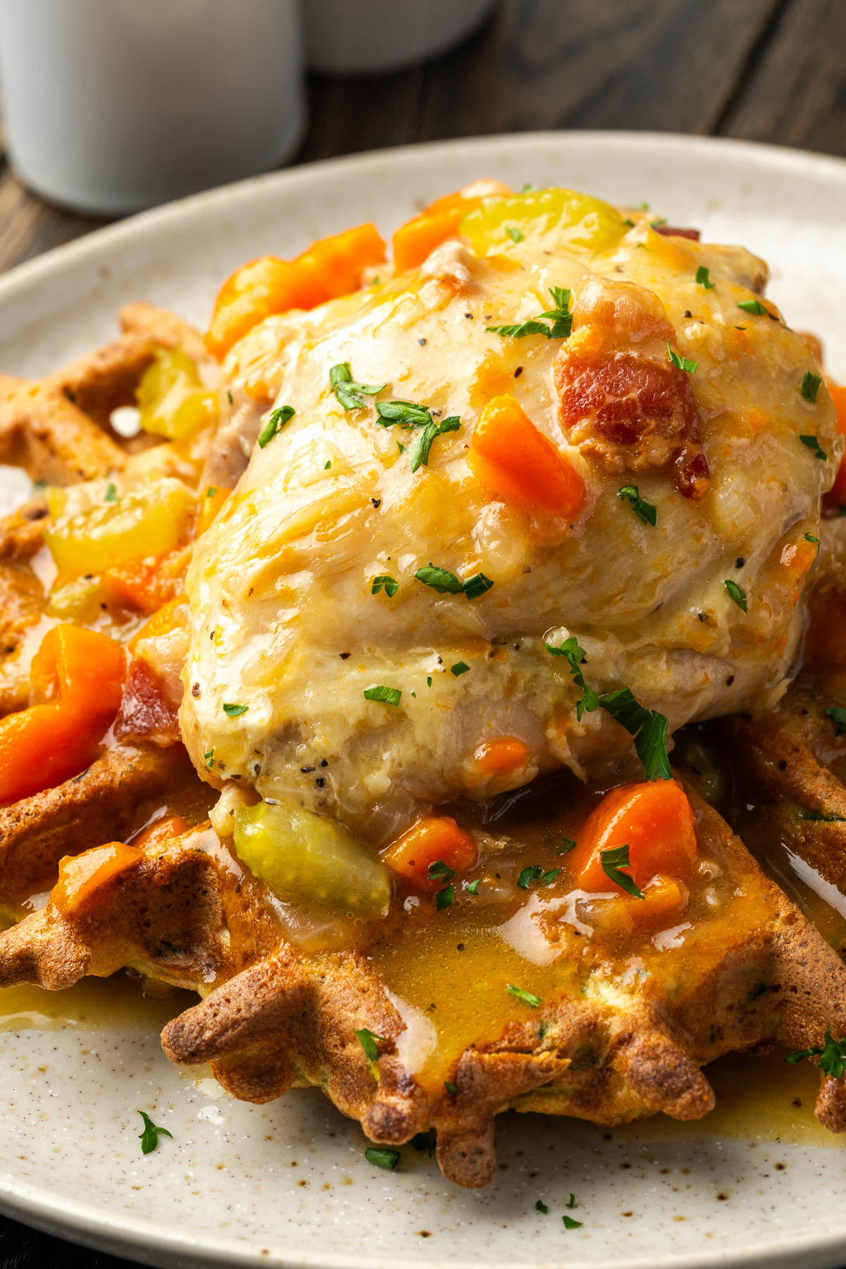 Chicken thighs in a sauce over waffles.