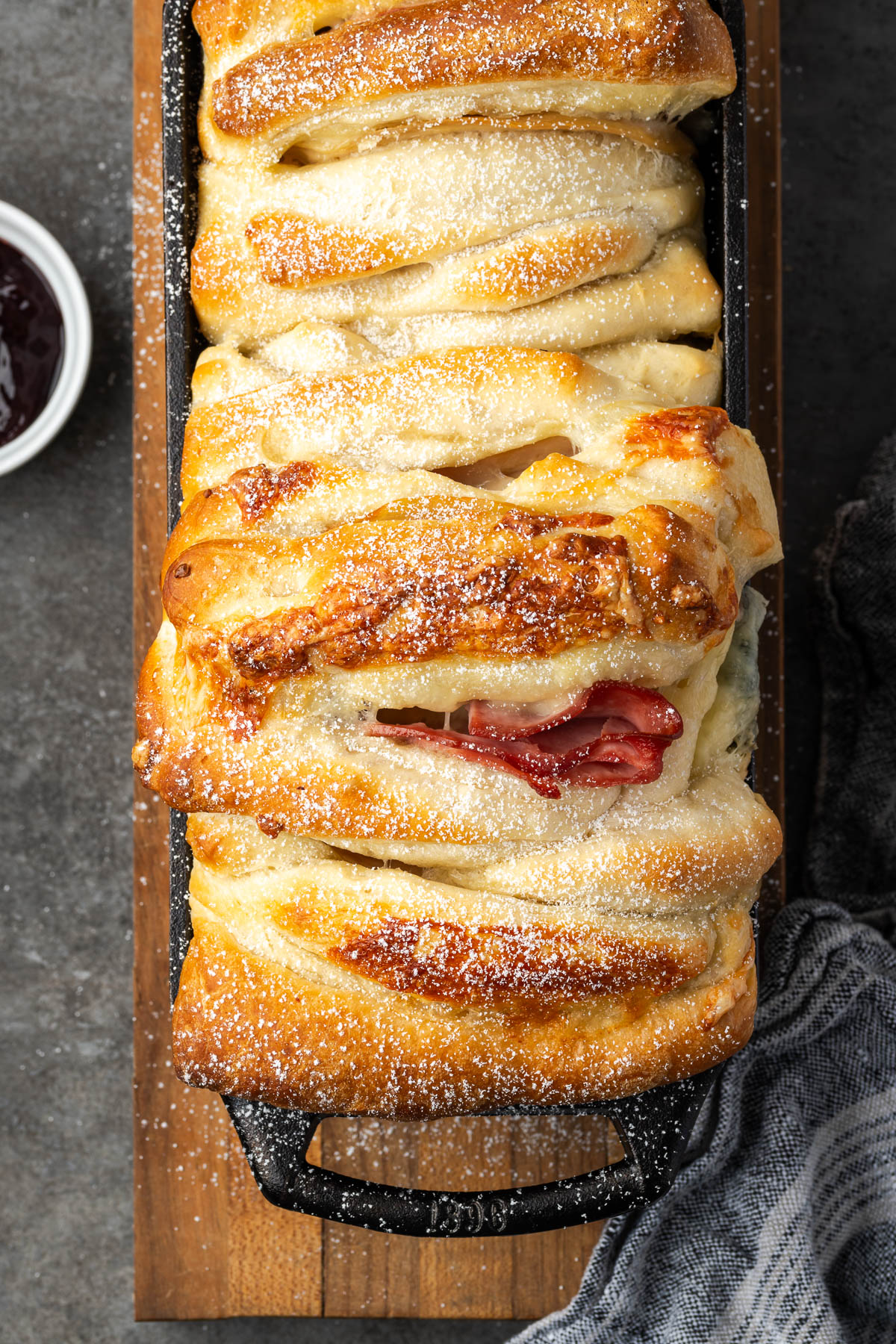 A monte cristo casseole with powdered sugar on top.