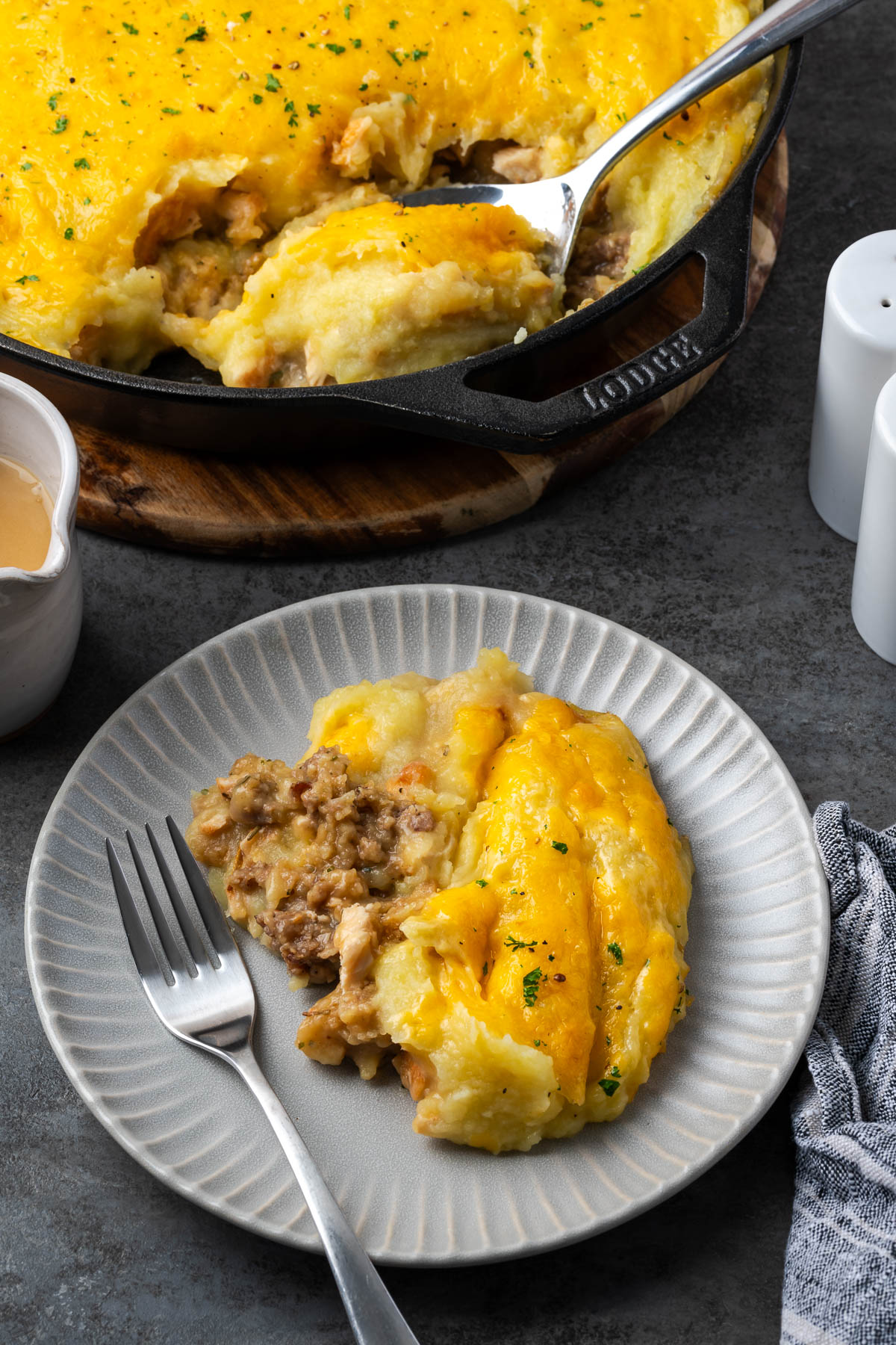 A plate with leftover turkey shepherd&rsquo;s pie beside a fork.