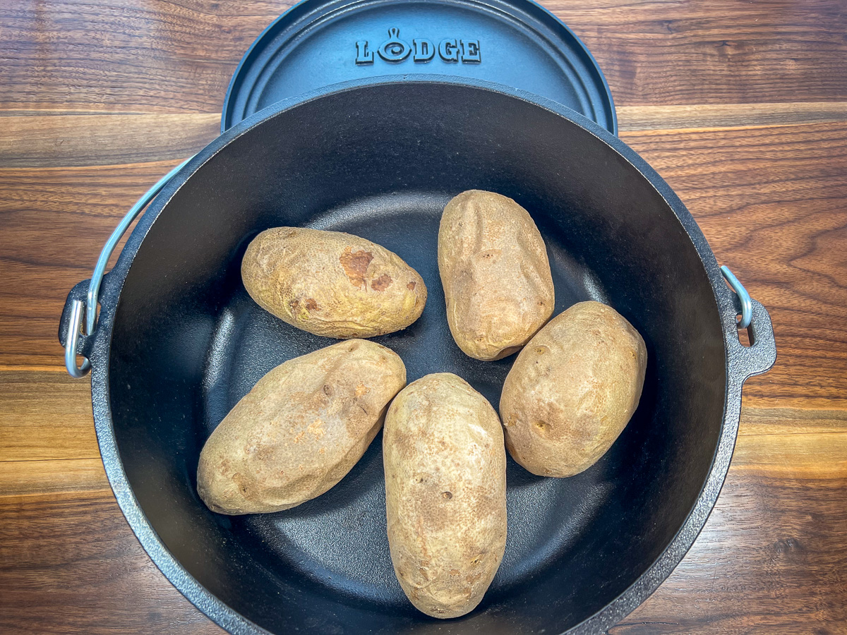 Campfire baked potatoes cooked and ready to go.