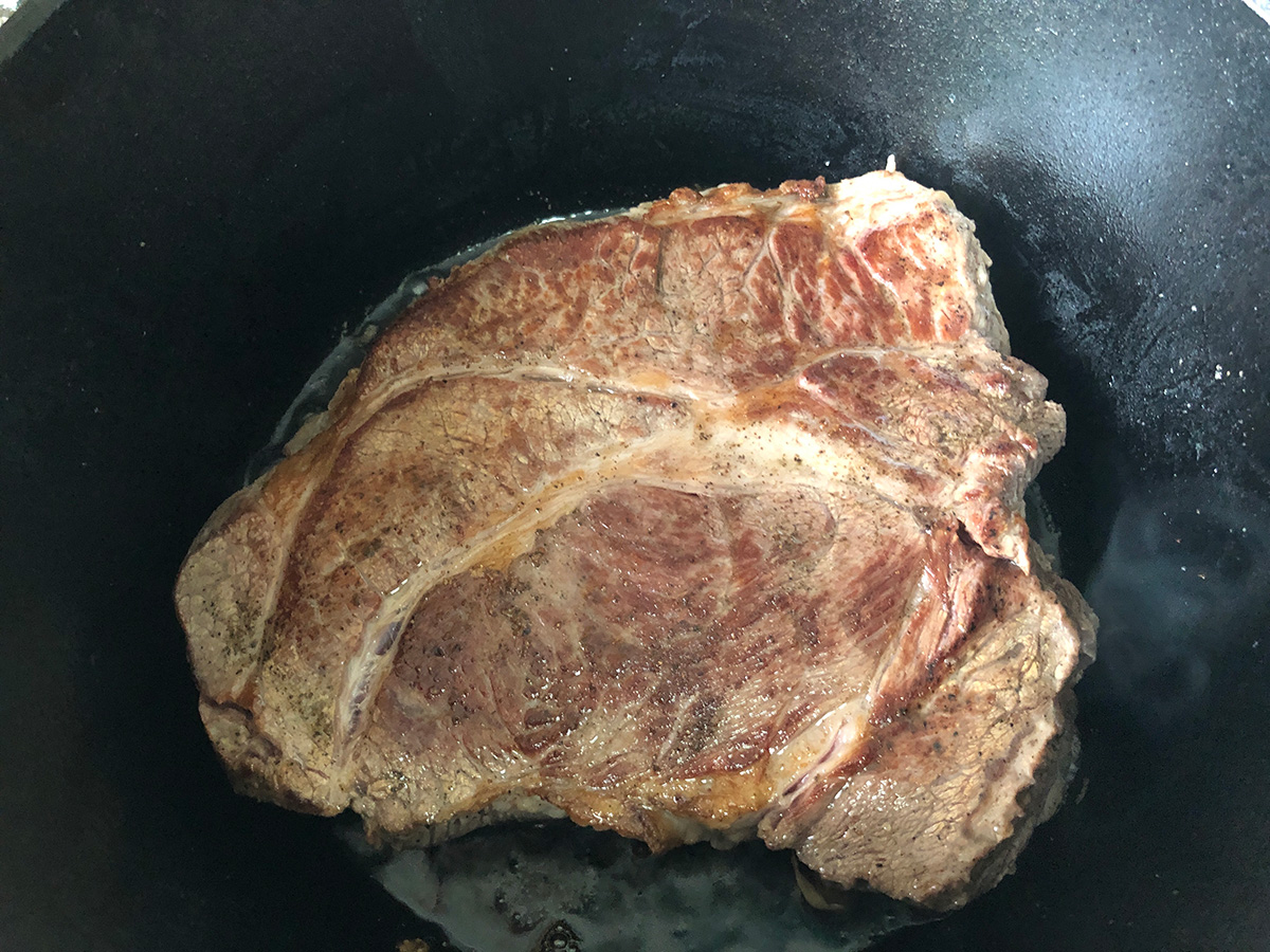 Chuck roast after searing on one side.