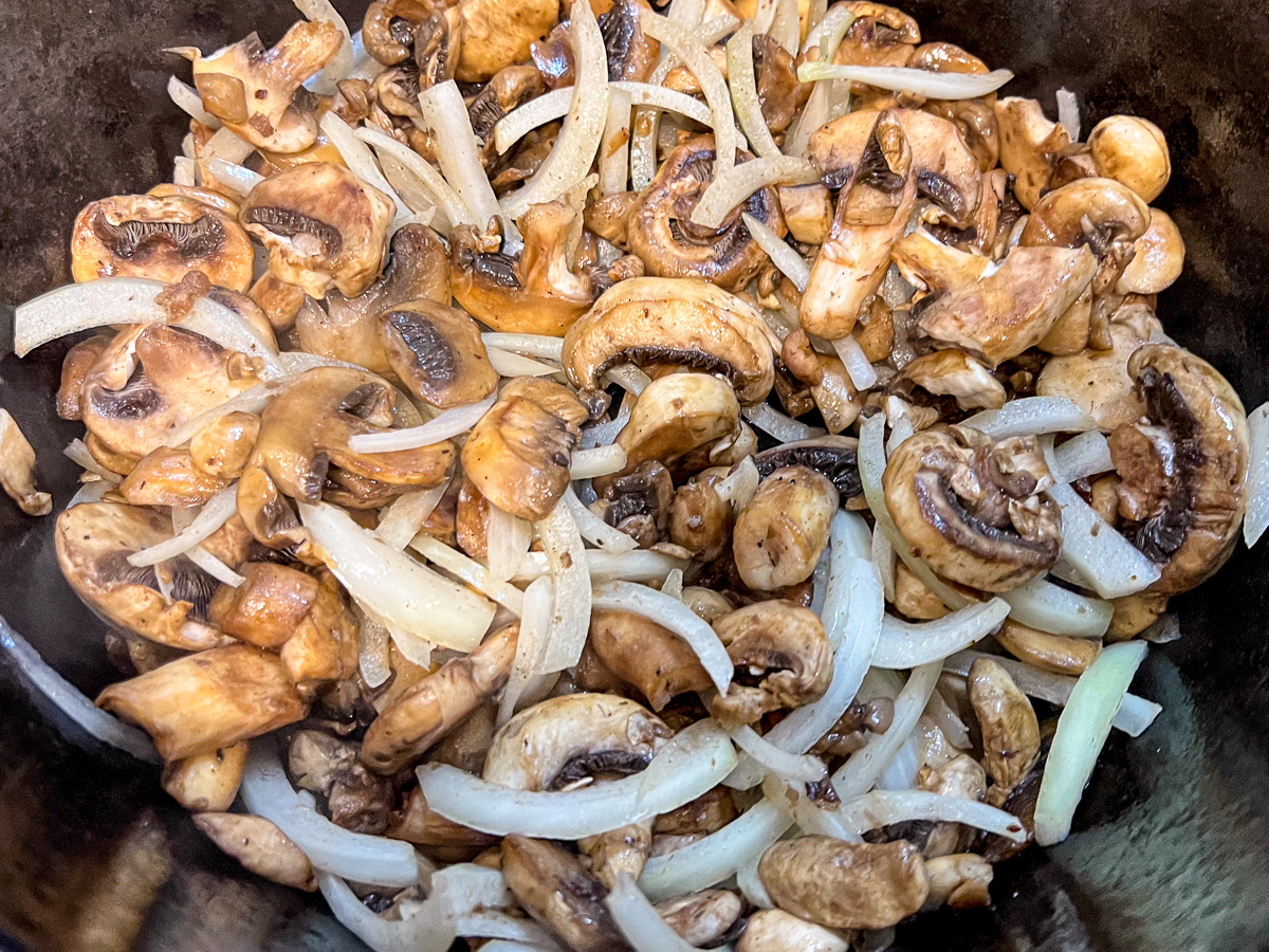 Cooking the vegetables to make beef stroganoff. 