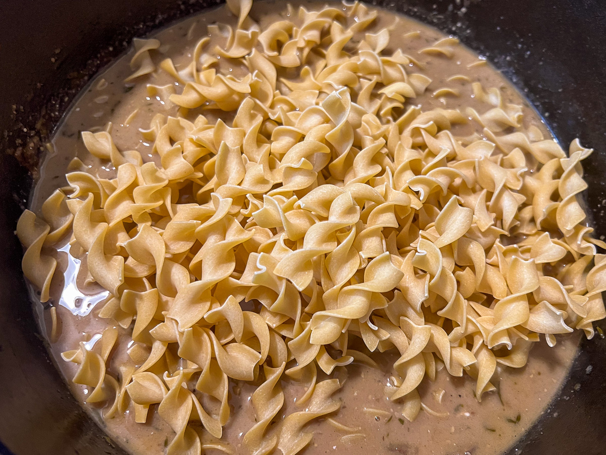 Adding the noodles to the pot. 