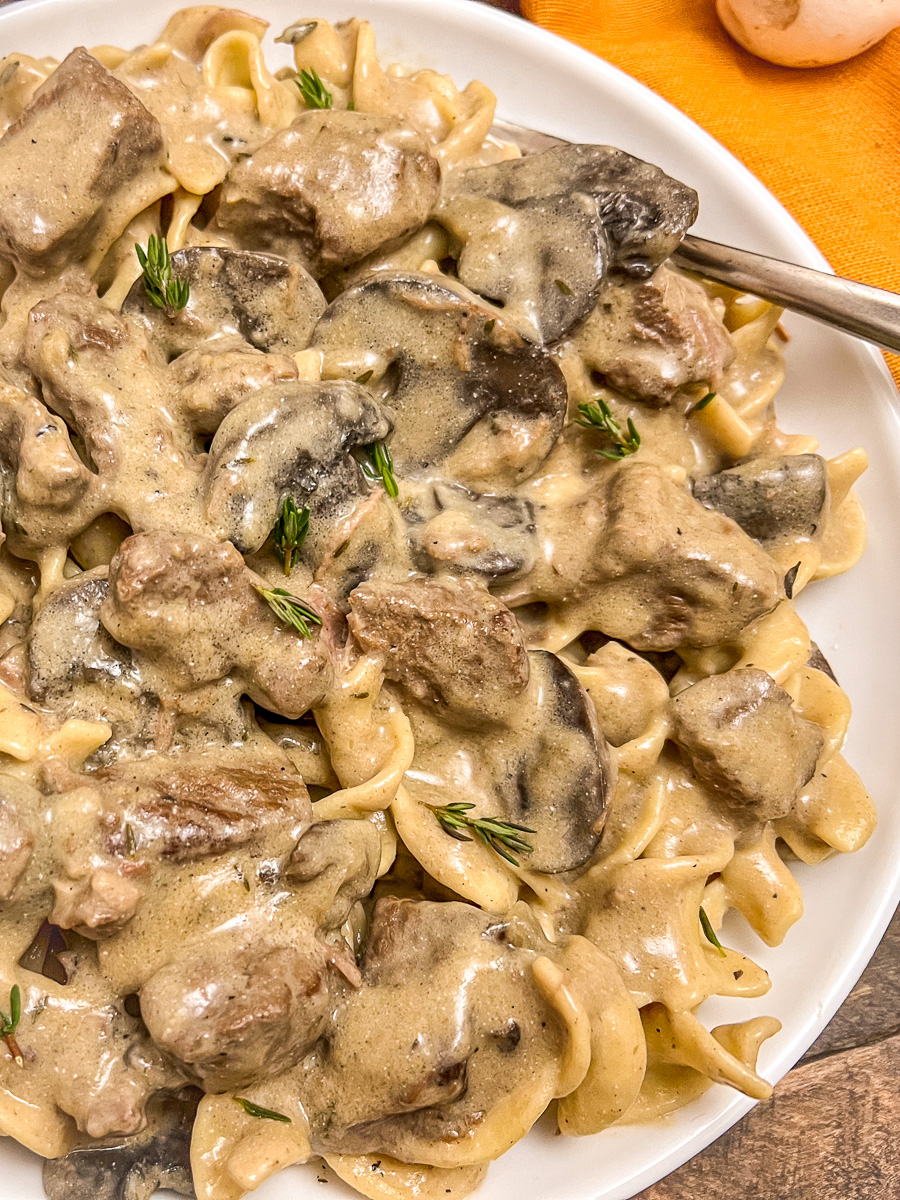 Dutch oven beef stroganoff in a white serving dish.