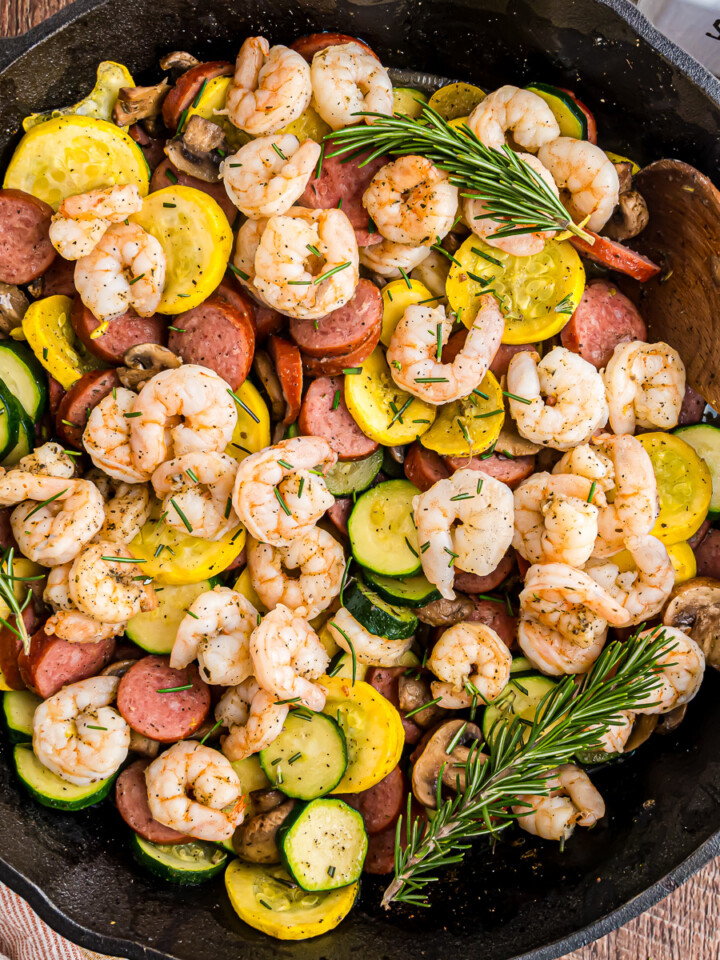 Rosemary cast iron shrimp and sausage skillet in a cast iron.