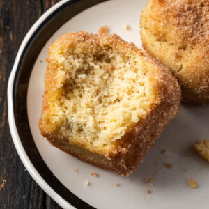 French breakfast puffs with a bite taken out of them.