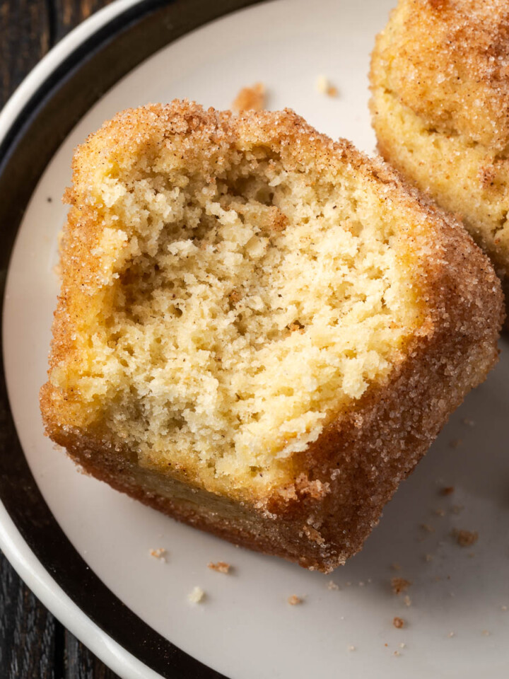French breakfast puffs with a bite taken out of them.
