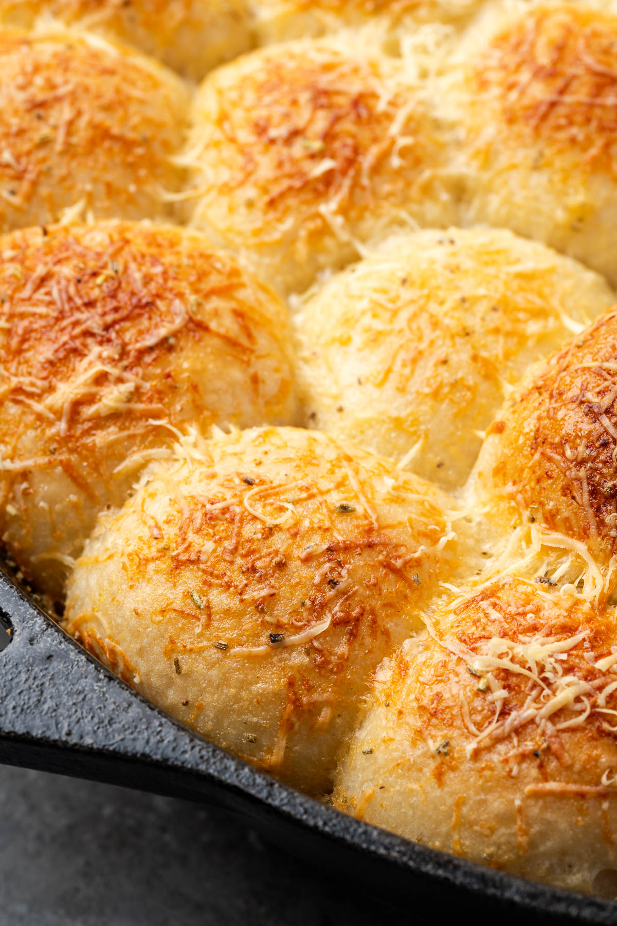 Rosemary garlic bread in a dutch oven topped with Parmesan cheese.