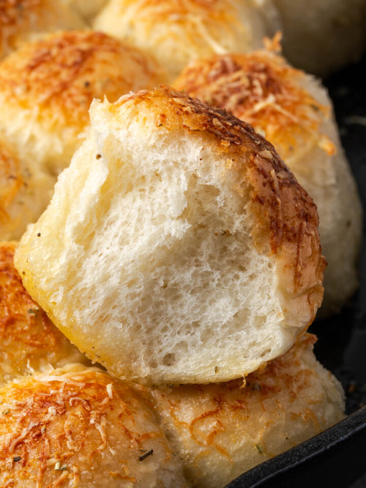 Dutch oven rosemary garlic bread pulled apart from the loaf.