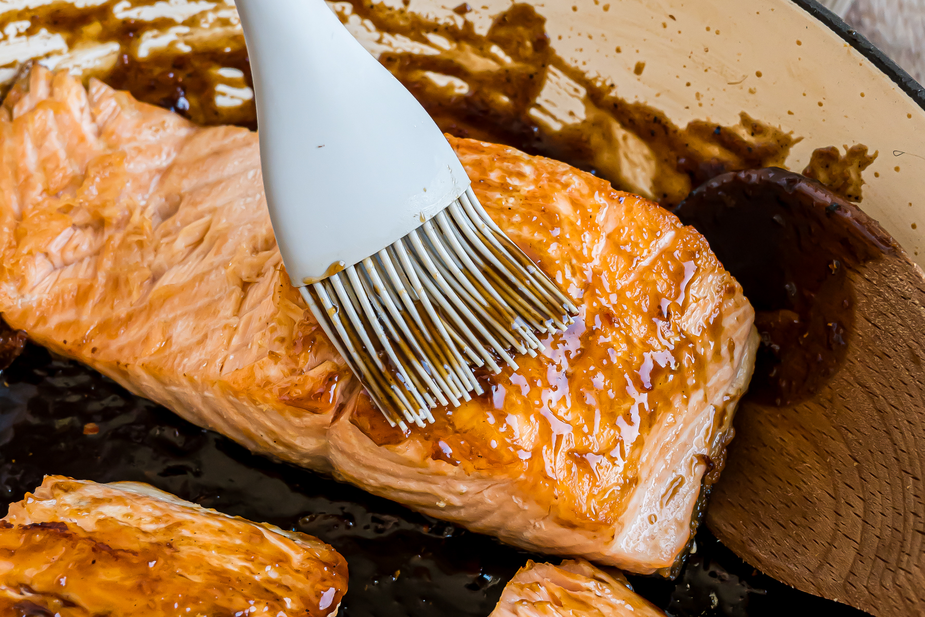 Glaze being brushed on the salmon.