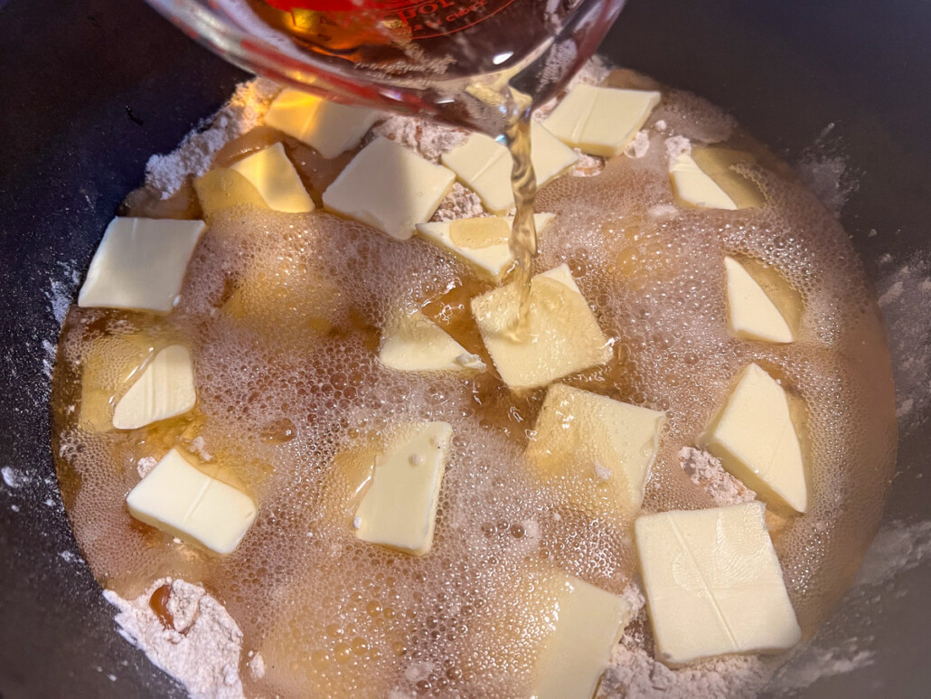 Cream soda being poured over the cake.