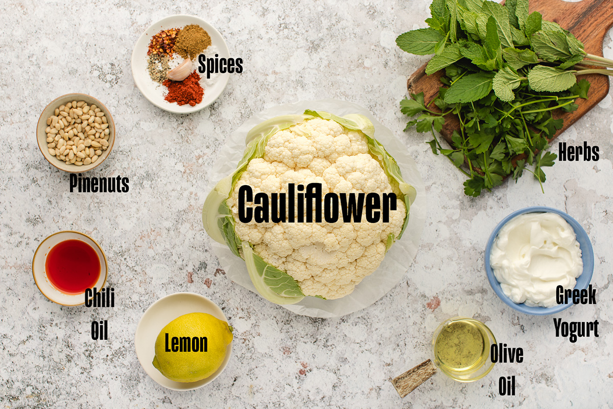 Ingredients to make this cauliflower steak on a table.