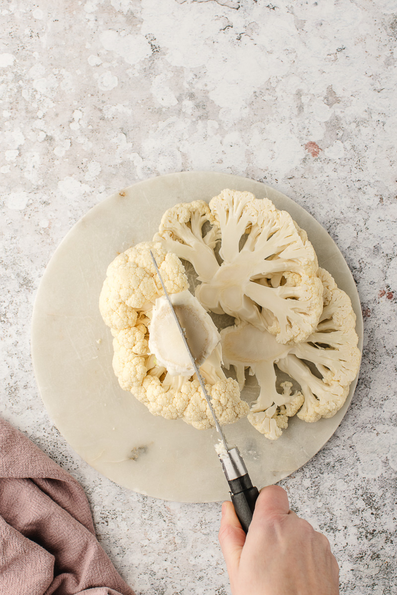 A head of cauliflower being sliced.