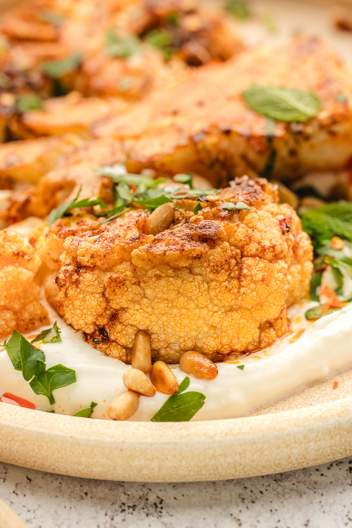Roasted cauliflower on a bed of yogurt sauce.