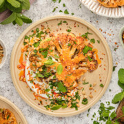 Roasted cauliflower steaks on a plate.
