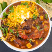 A serving of 7 can soup in a white bowl garnished with cilantro.