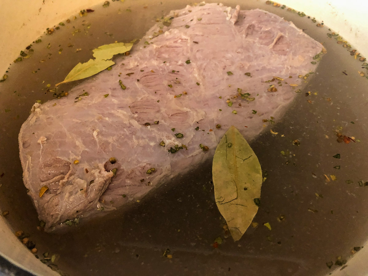 Corned beef with the spice packet and bay leaves added.