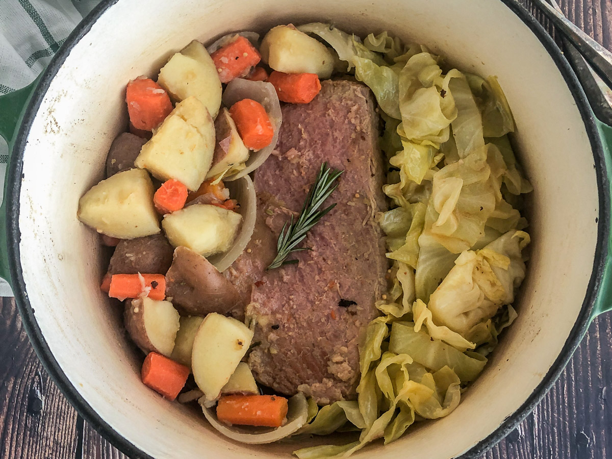 Cooked corned beef and cabbage in a Dutch oven.