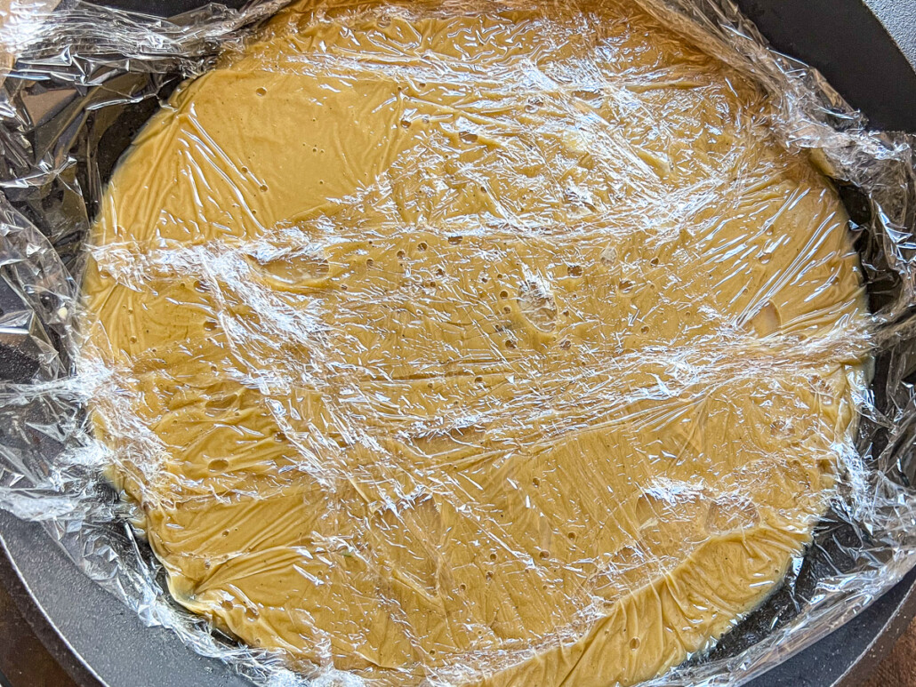 Plastic wrap firmly pressed against the gravy to prevent a skin from forming.