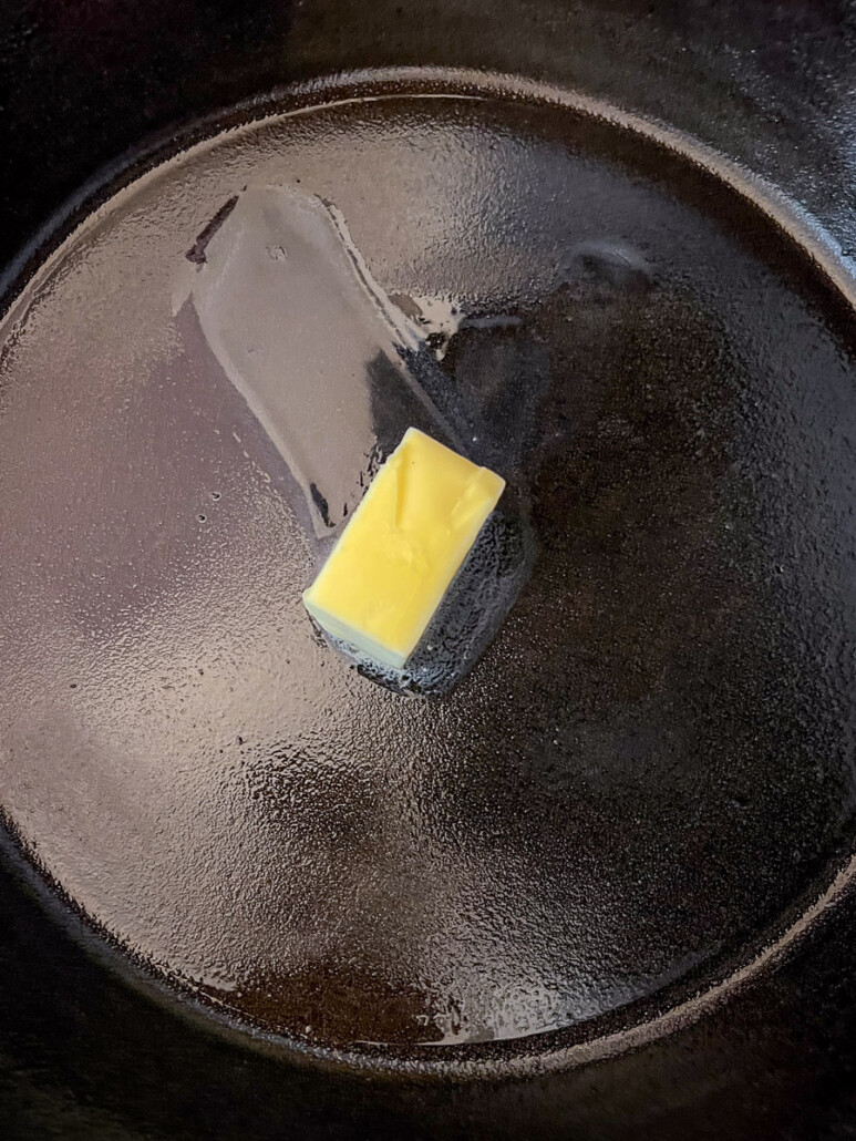 Butter melting in the skillet.