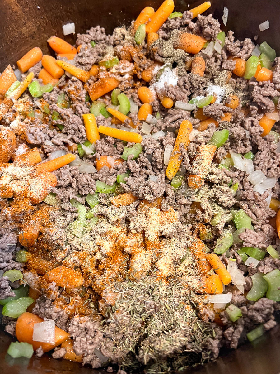 The seasonings have been added to the mixed meat and vegetables.