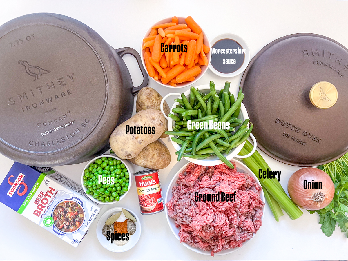 Ingredients to make ground beef stew in a Dutch oven.