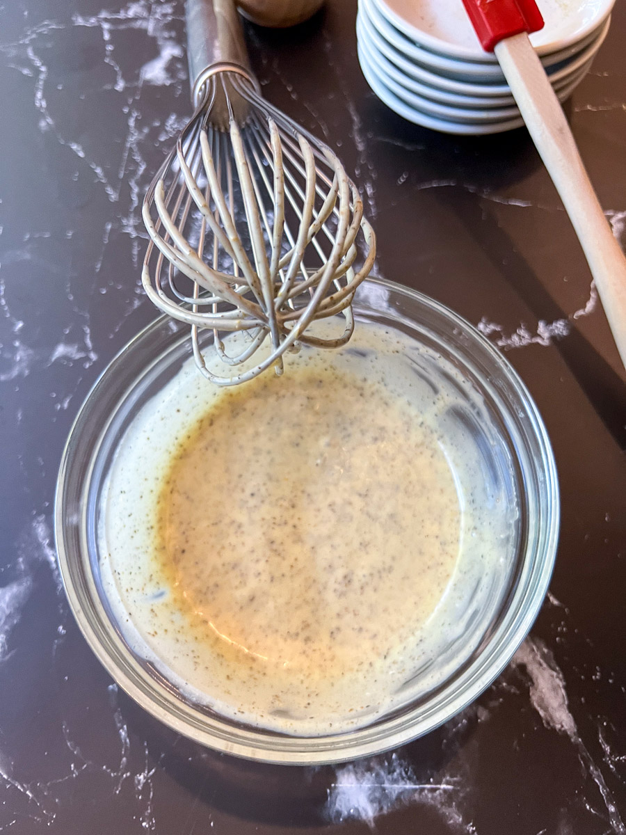 Whisking mayonnaise into the simple coleslaw dressing until smooth and creamy