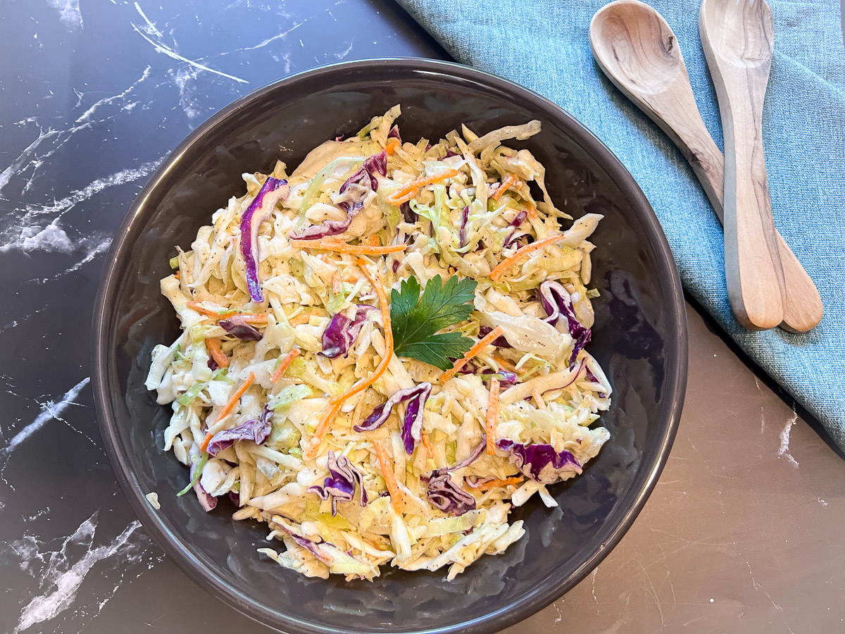 Simple coleslaw recipe served in a black bowl, ready to eat